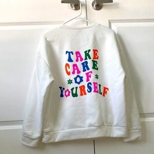 Shein white crew neck sweatshirt, says Take Care of Yourself on back.